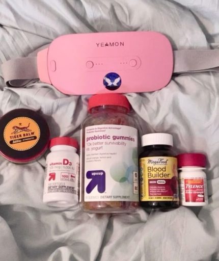 1. YEAMON device – Likely a portable heating pad or massager (used for menstrual cramps or muscle relief). 2. Tiger Balm Ultra Strength – Topical ointment for muscle aches, pain relief. 3. Up & Up Vitamin D3 (5,000 IU) – Vitamin D supplement (supports bone and immune health). 4. Up & Up Probiotic Gummies – Digestive health supplement with probiotics. 5. MegaFood Blood Builder (Iron Mini) – Iron supplement (boosts energy and helps with iron deficiency). 6. Tylenol Extra Strength – Acetaminophen pain reliever (used for cramps, headaches, etc.).